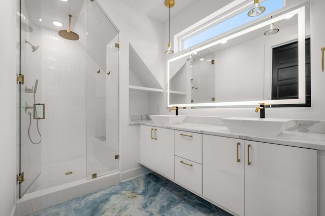 full bathroom featuring double vanity, a shower stall, and a sink