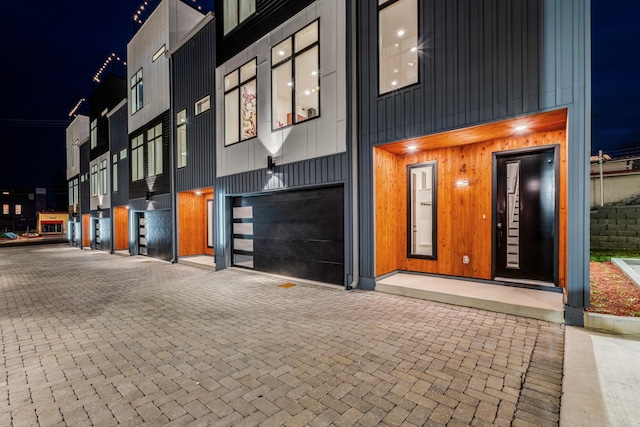 view of front of property featuring decorative driveway and an attached garage