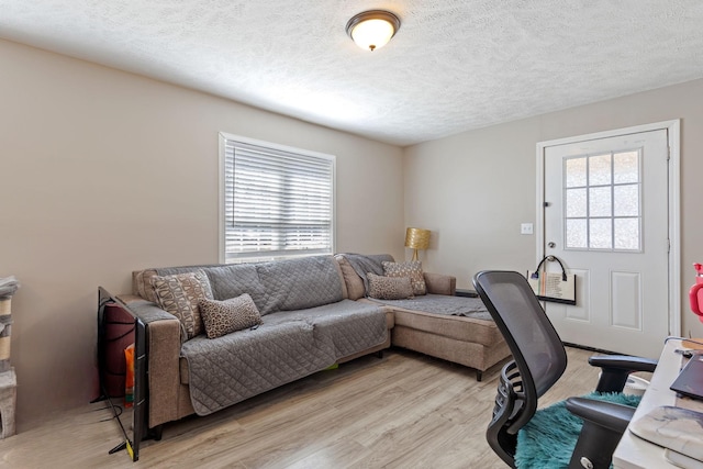 home office featuring light wood-style floors and a textured ceiling