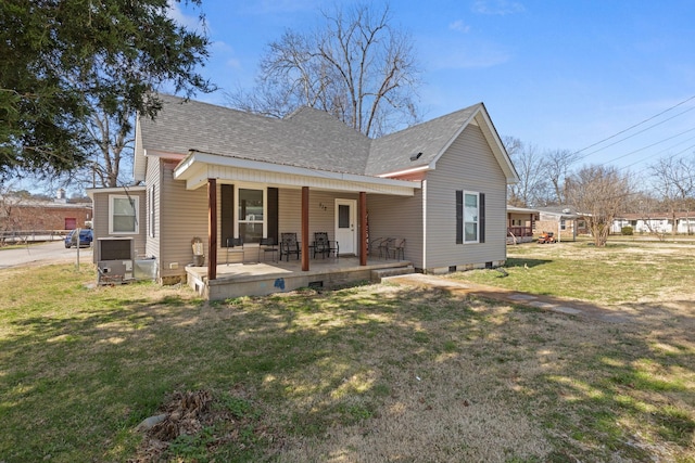 bungalow featuring crawl space, a front lawn, and roof with shingles