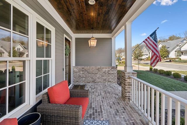 view of patio / terrace with covered porch and a residential view