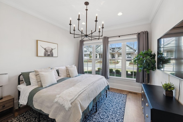 bedroom featuring ornamental molding, dark wood-style flooring, visible vents, and baseboards