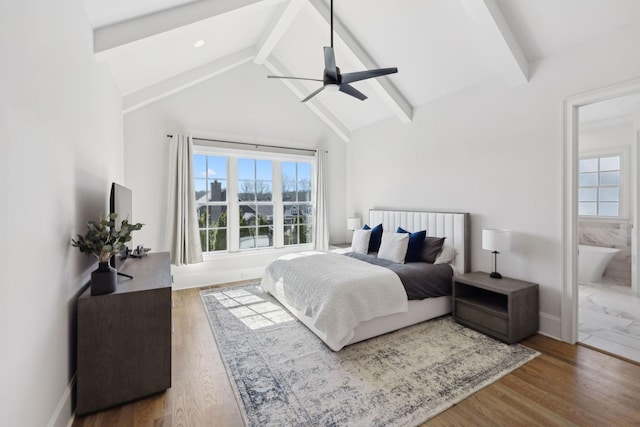 bedroom with multiple windows, beamed ceiling, and wood finished floors