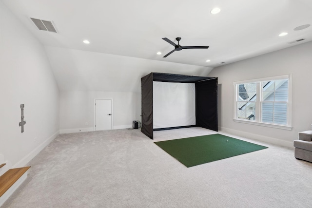 carpeted cinema with lofted ceiling, golf simulator, visible vents, and recessed lighting