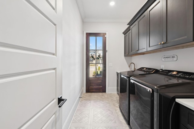 laundry room featuring ornamental molding, washer and dryer, cabinet space, and baseboards