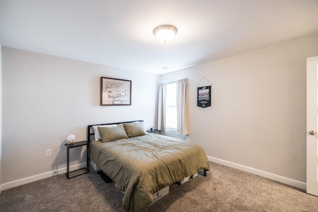 carpeted bedroom featuring baseboards