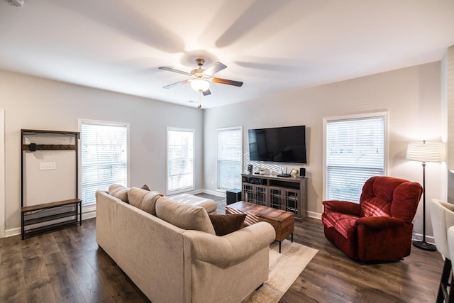 living area featuring dark wood-style floors, ceiling fan, and baseboards