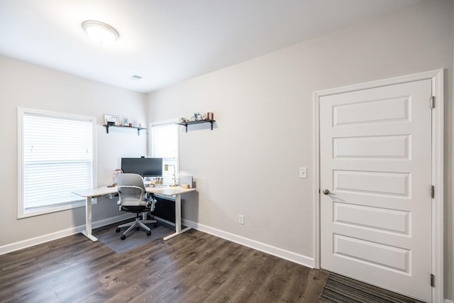 office with dark wood-style floors and baseboards