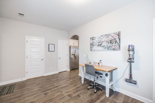 office area with baseboards, visible vents, and dark wood-type flooring