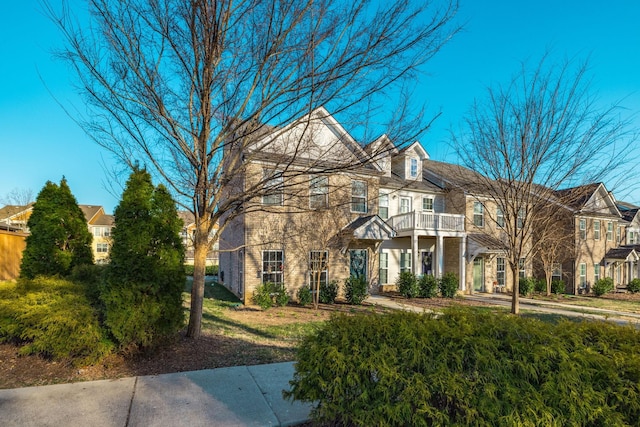 view of front of house featuring a residential view and a balcony