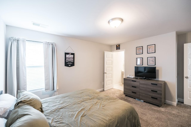 bedroom featuring light colored carpet, visible vents, and baseboards