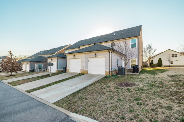 view of front of house featuring a garage, driveway, brick siding, and roof with shingles