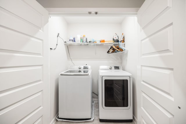 washroom featuring laundry area and washing machine and clothes dryer