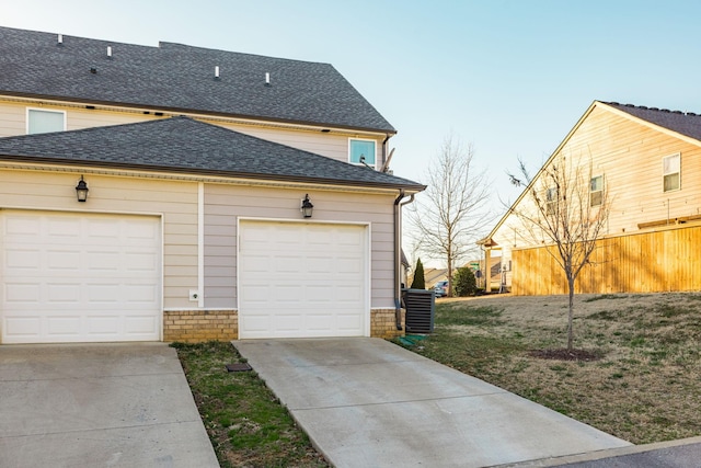 garage featuring concrete driveway