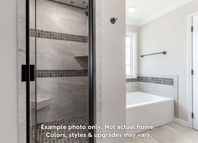 full bath with a stall shower, ornamental molding, and a garden tub