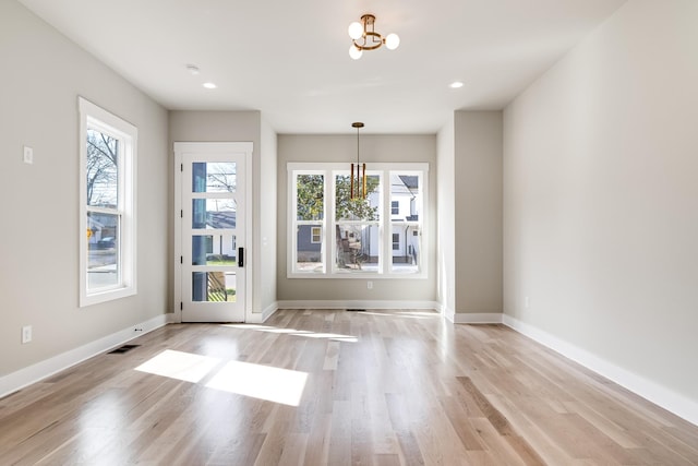 interior space featuring plenty of natural light, visible vents, and a notable chandelier