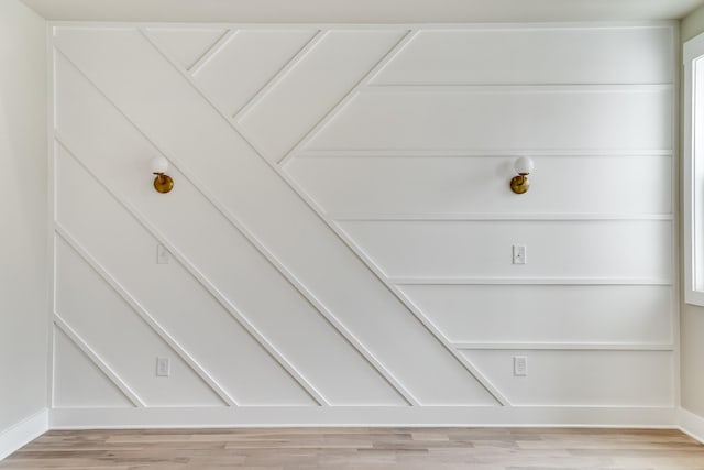 interior details featuring baseboards and wood finished floors