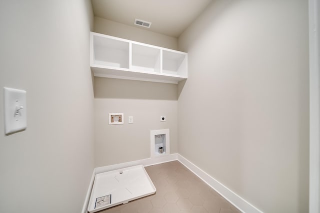 laundry area with laundry area, washer hookup, visible vents, baseboards, and electric dryer hookup