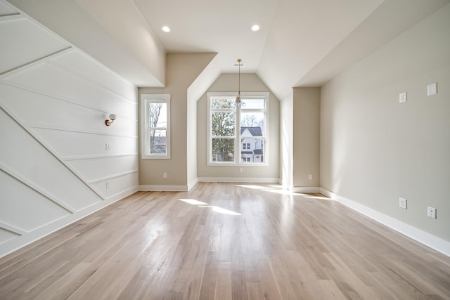 bonus room featuring recessed lighting, vaulted ceiling, light wood-style flooring, and baseboards