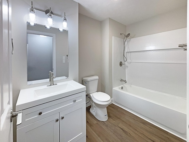 full bath with shower / bathtub combination, vanity, toilet, and wood finished floors