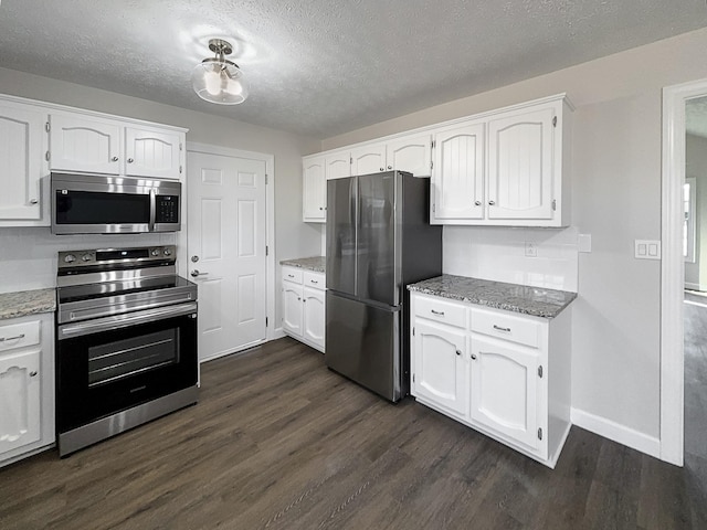 kitchen with white cabinetry, stainless steel appliances, and dark wood-style flooring