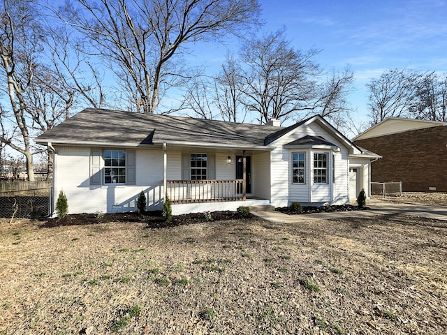 single story home with a chimney, fence, a porch, and brick siding