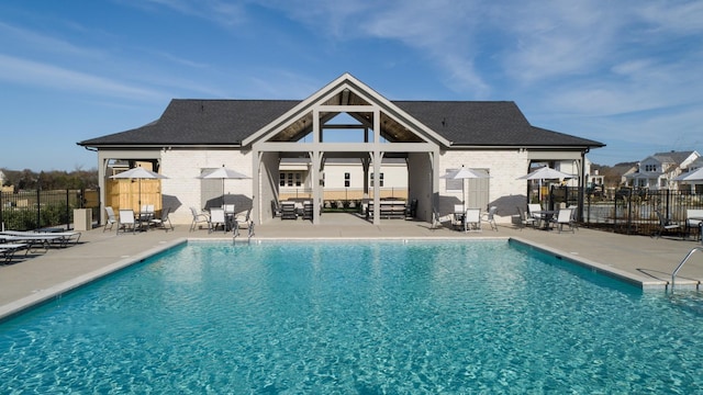 pool with a patio and fence