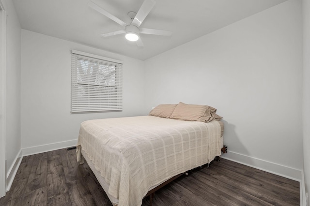 bedroom featuring ceiling fan, dark wood finished floors, and baseboards