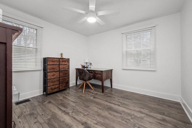 office area with a ceiling fan, visible vents, baseboards, and wood finished floors