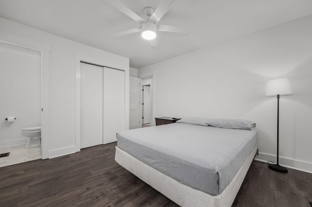 bedroom with a ceiling fan, a closet, dark wood finished floors, and baseboards