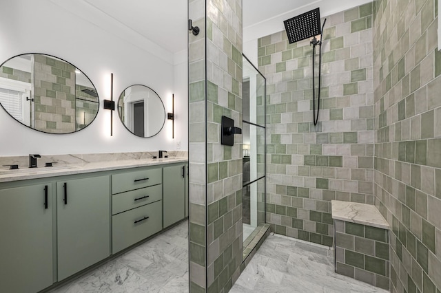 full bath featuring double vanity, marble finish floor, walk in shower, and a sink