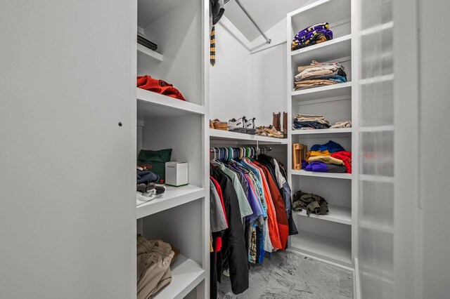 spacious closet with marble finish floor