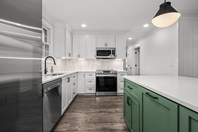 kitchen with green cabinetry, white cabinetry, stainless steel appliances, and a sink