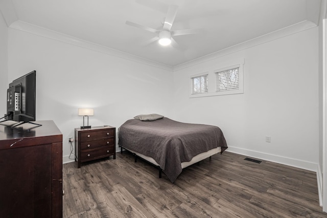 bedroom with ornamental molding, visible vents, dark wood finished floors, and baseboards