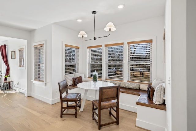 dining space featuring recessed lighting, breakfast area, light wood-type flooring, and baseboards