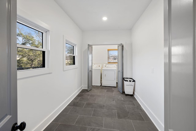 hallway with dark tile patterned floors, washer and clothes dryer, recessed lighting, and baseboards