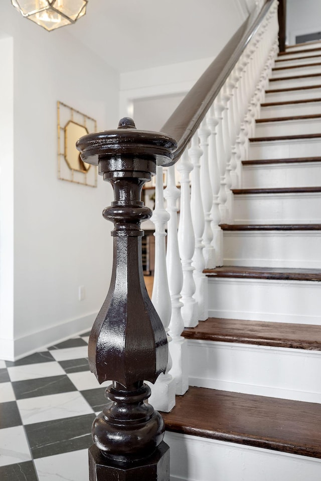 stairway featuring baseboards and tile patterned floors