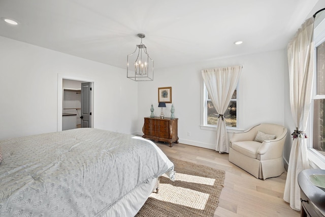 bedroom featuring a notable chandelier, baseboards, light wood-style flooring, and recessed lighting