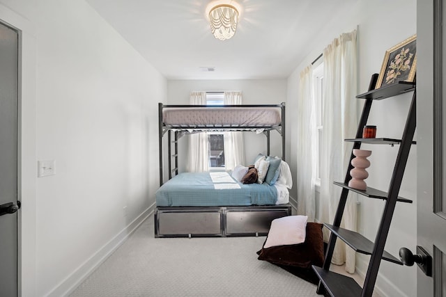 carpeted bedroom featuring visible vents and baseboards