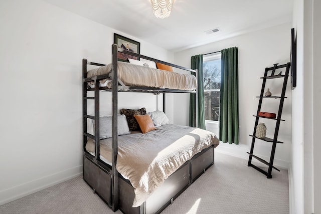 bedroom featuring carpet floors, visible vents, and baseboards