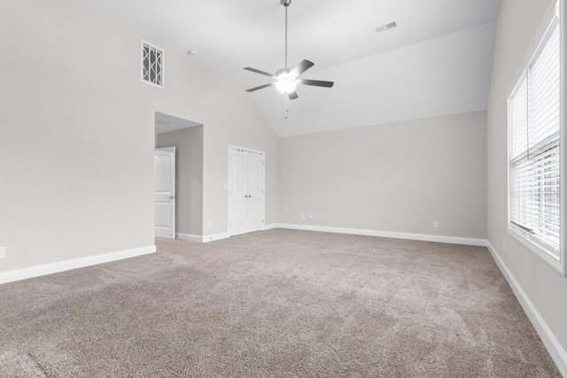 carpeted spare room featuring high vaulted ceiling, ceiling fan, visible vents, and baseboards