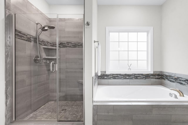 bathroom with a garden tub and a shower stall