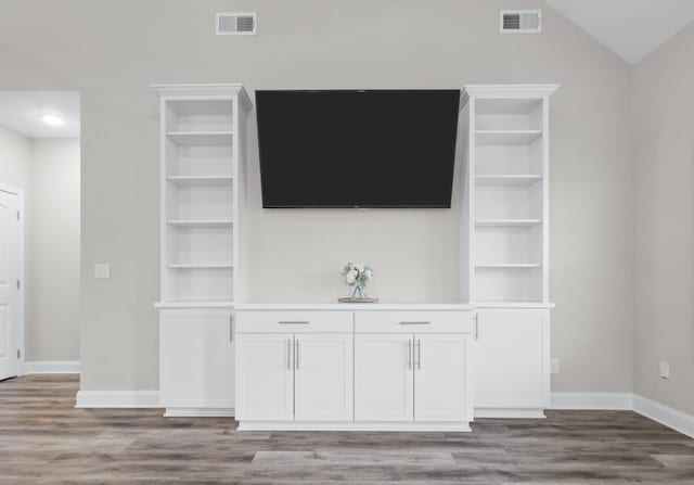 unfurnished living room featuring baseboards, visible vents, and light wood finished floors