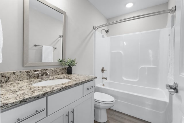 bathroom with shower / washtub combination, vanity, toilet, and wood finished floors