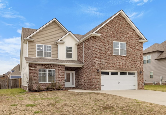 traditional home with driveway, fence, a front lawn, and brick siding