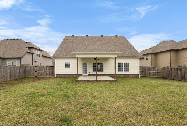 back of property featuring a fenced backyard, a lawn, a ceiling fan, and a patio