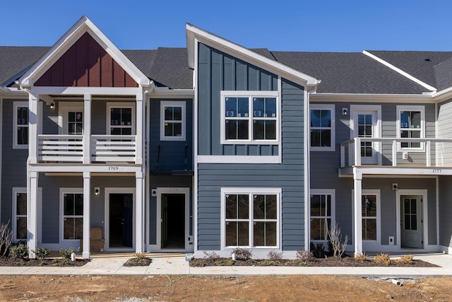 view of front of house featuring board and batten siding and roof with shingles