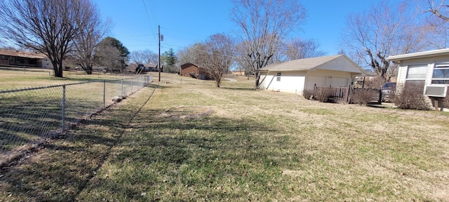 view of yard with an outbuilding, cooling unit, fence, and a garage