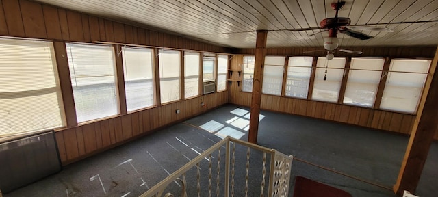 unfurnished sunroom featuring ceiling fan