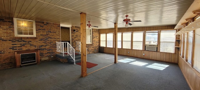 unfurnished sunroom featuring cooling unit and a ceiling fan